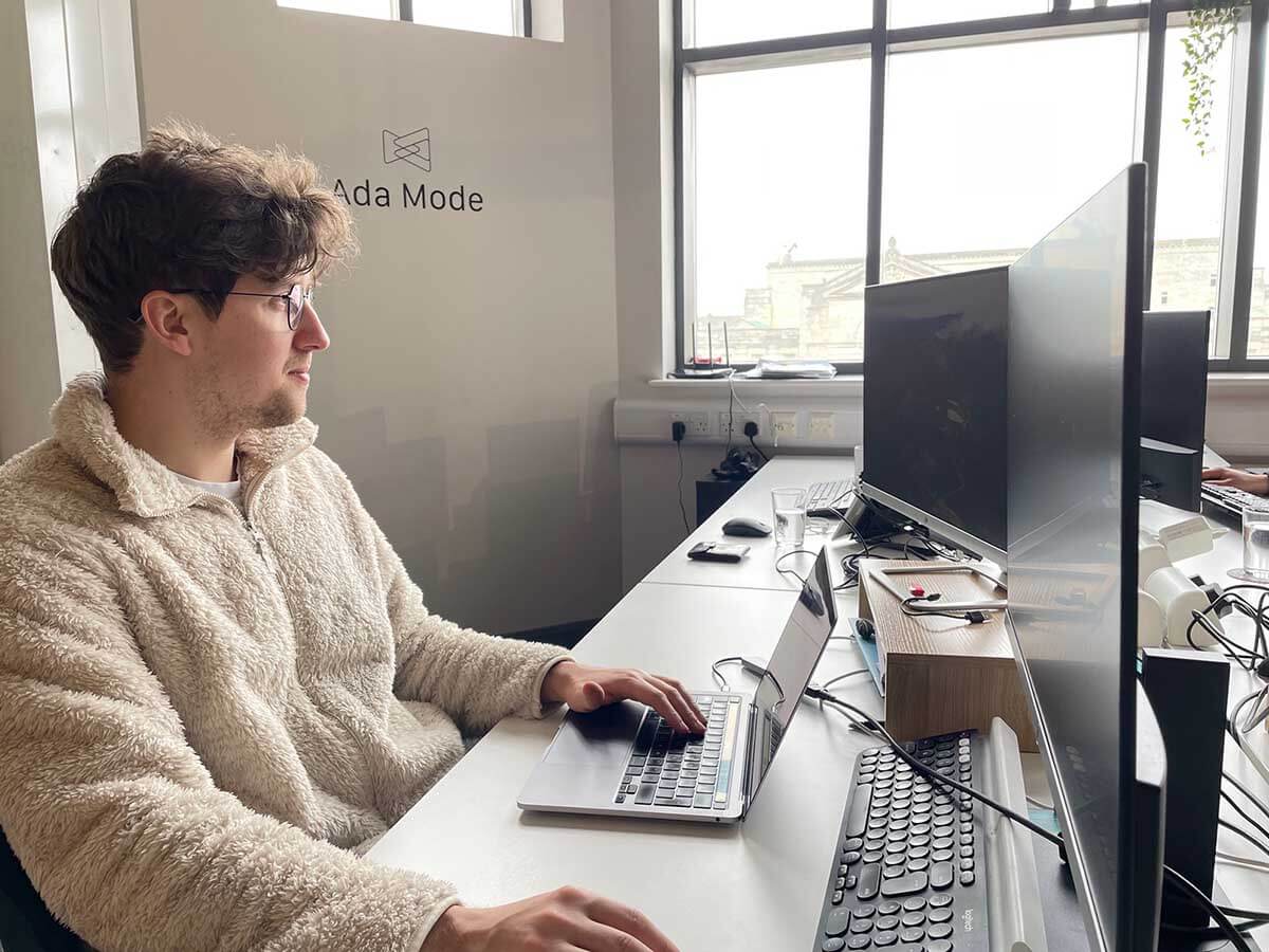 A member of the Ada Mode team working at a desk